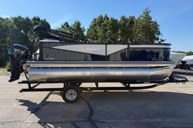 Slide: The Image of 2026 Lowe LF 194 pontoon boat on trailer, parked outdoors, sunny day. - 4