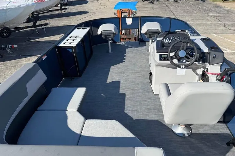 Slide: The Image of 2026 Lowe LF 194 boat interior with seating, steering console, and storage compartments. - 7