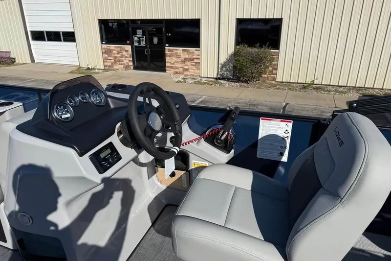 Slide: The Image of 2026 Lowe LF 194 boat cockpit with steering wheel and control panel. - 8