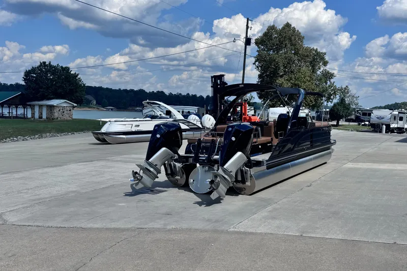 Slide: The Image of 2026 Bennington 27RSBAT2 pontoon boat parked on a sunny day near a lake. - 10