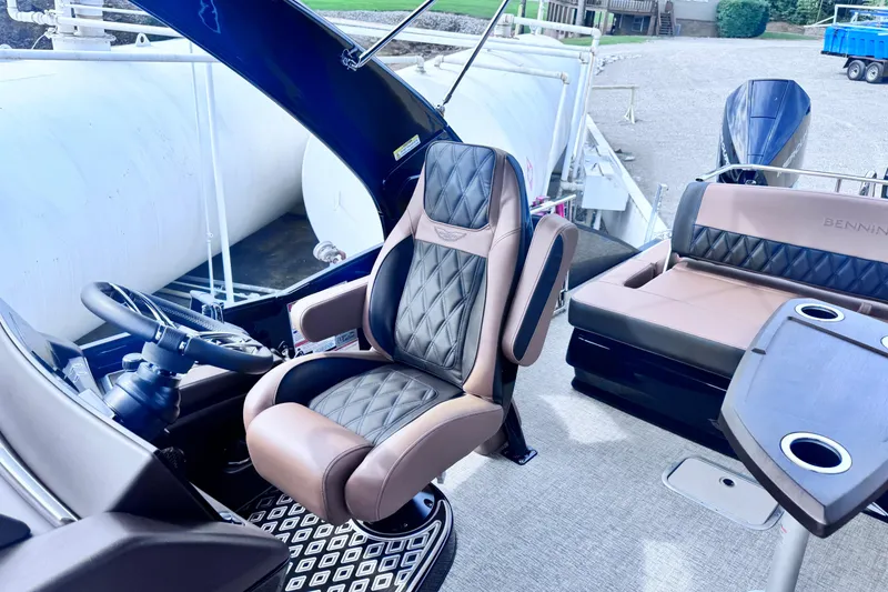 Slide: The Image of 2026 Bennington 27RSBAT2 boat interior with luxurious seating and steering wheel. - 4