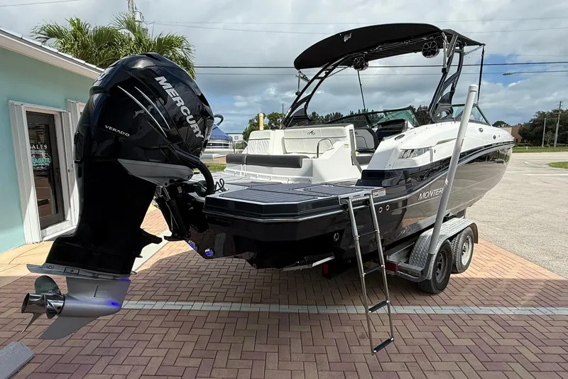 Slide: The Image of 2018 Monterey M-65 boat with Mercury Verado engine on trailer, parked outdoors. - 11