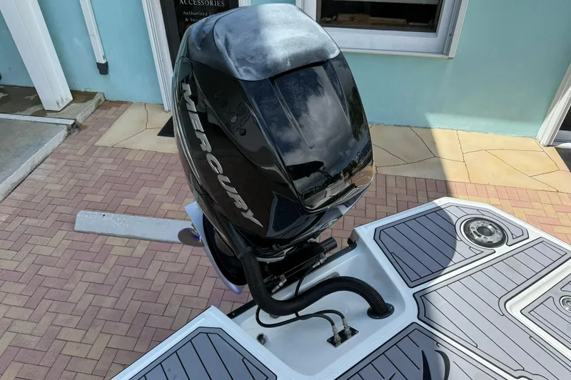 Slide: The Image of Outboard motor on a 2018 Monterey M-65 boat, docked on a brick patio. - 16