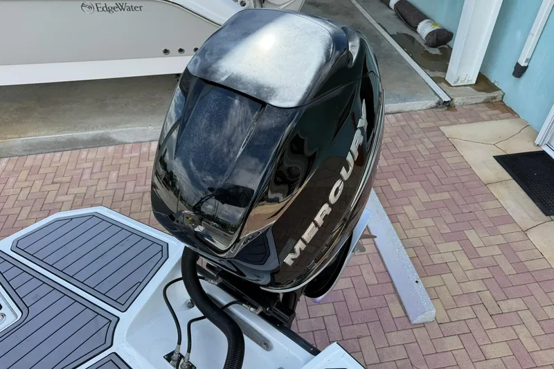 Slide: The Image of Mercury outboard motor on a 2018 Monterey M-65 boat, docked on a brick patio. - 17