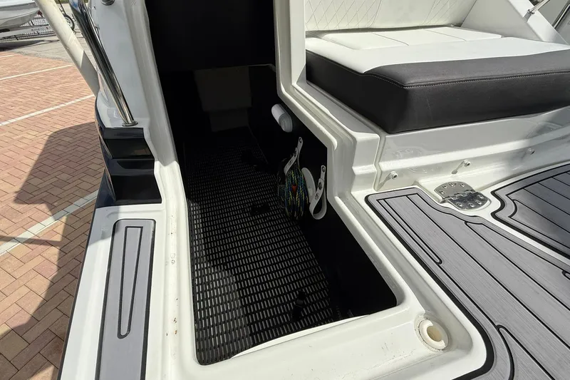 Slide: The Image of Interior view of a 2018 Monterey M-65 boat, featuring seating and storage area. - 20