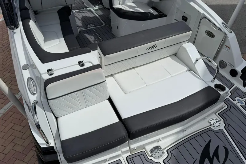 Slide: The Image of Luxury seating on a 2018 Monterey M-65 boat, featuring sleek black and white upholstery. - 21