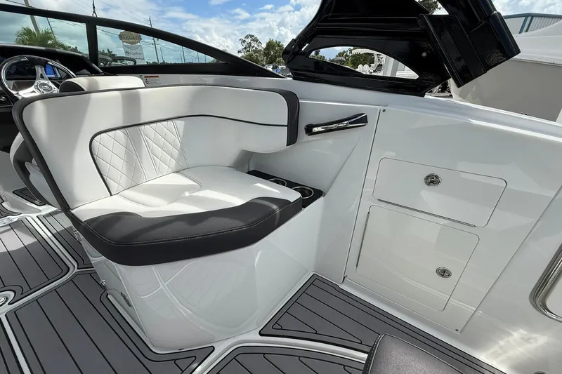 Slide: The Image of 2018 Monterey M-65 boat interior with white seating and storage compartments. - 25