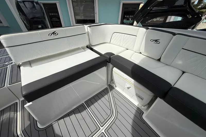 Slide: The Image of Luxurious seating on 2018 Monterey M-65 boat with white and black upholstery. - 28