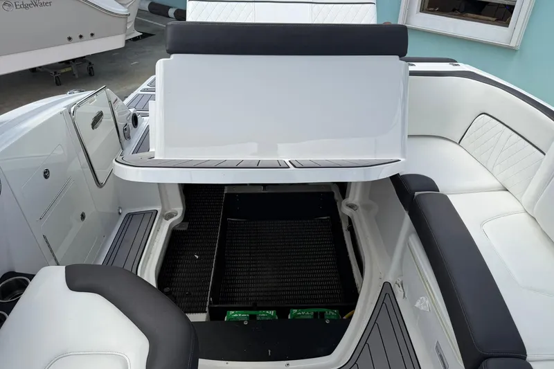 Slide: The Image of 2018 Monterey M-65 boat interior with open storage compartment and cushioned seating. - 30