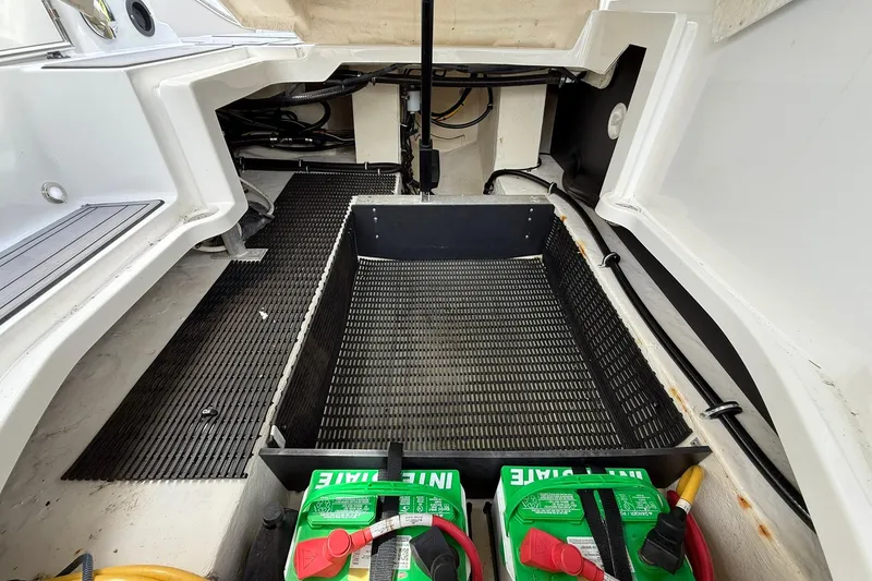 Slide: The Image of Open engine compartment of 2018 Monterey M-65 boat with visible batteries and wiring. - 31