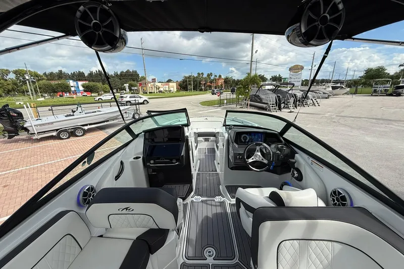 Slide: The Image of Interior view of a 2018 Monterey M-65 boat, showcasing seating and dashboard. - 32