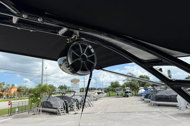 Slide: The Image of Speaker mounted on a 2018 Monterey M-65 boat, with a marina in the background. - 34