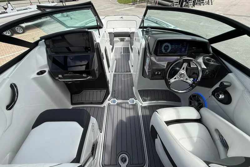Slide: The Image of 2018 Monterey M-65 boat interior with sleek dashboard, steering wheel, and modern seating. - 35