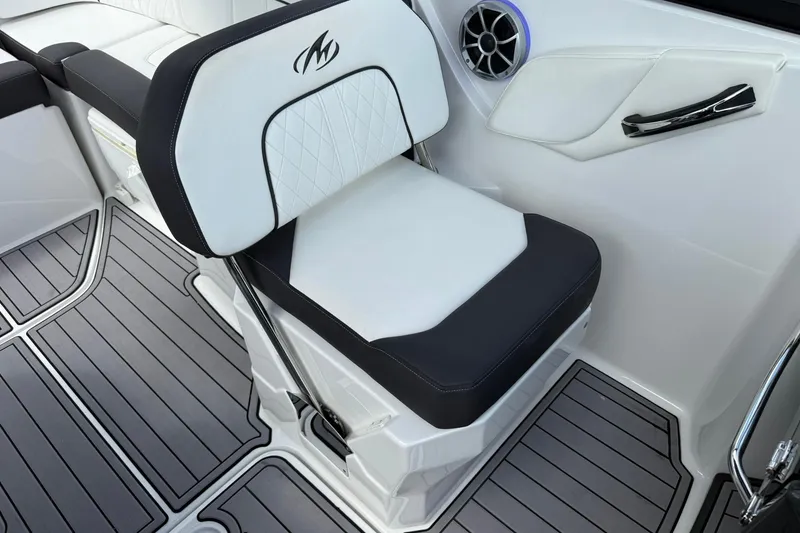 Slide: The Image of White and black seat in 2018 Monterey M-65 boat interior, featuring sleek design and speaker. - 41