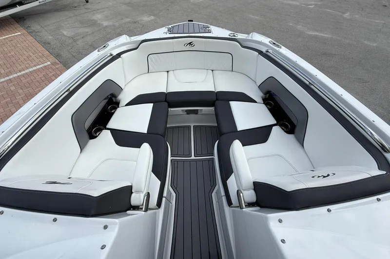 Slide: The Image of Luxurious seating area on a 2018 Monterey M-65 boat, featuring sleek white and black upholstery. - 43
