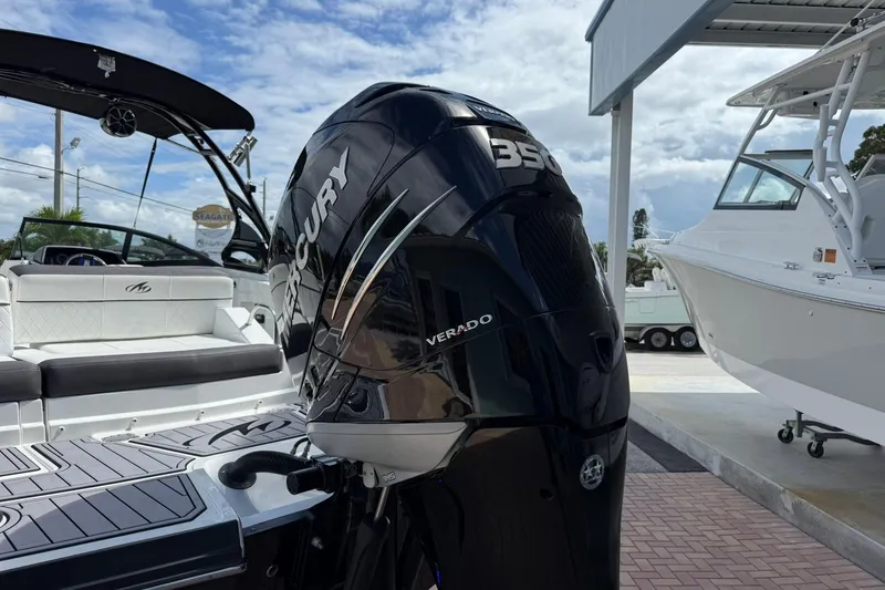 Slide: The Image of 2018 Monterey M-65 boat with Mercury Verado 350 engine, docked under a cloudy sky. - 5