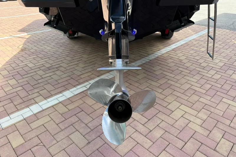 Slide: The Image of Close-up of a 2018 Monterey M-65 boat propeller on a brick-paved surface. - 8