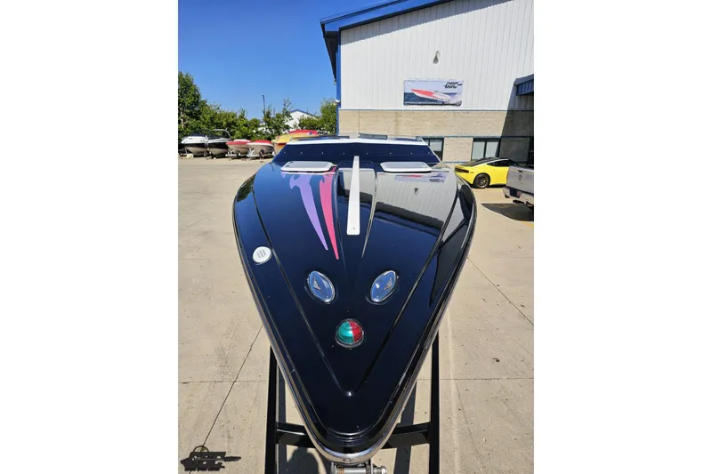 Slide: The Image of 2005 Baja 25 Outlaw boat with sleek black design and vibrant graphics. - 14