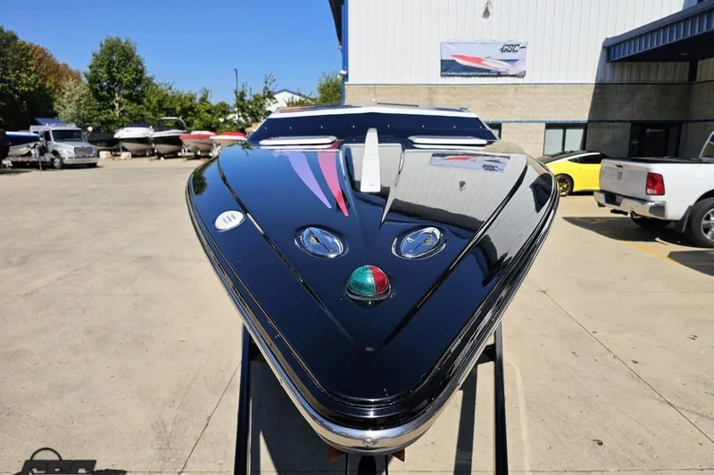 Slide: The Image of 2005 Baja 25 Outlaw boat displayed outdoors, showcasing sleek design and vibrant colors. - 15