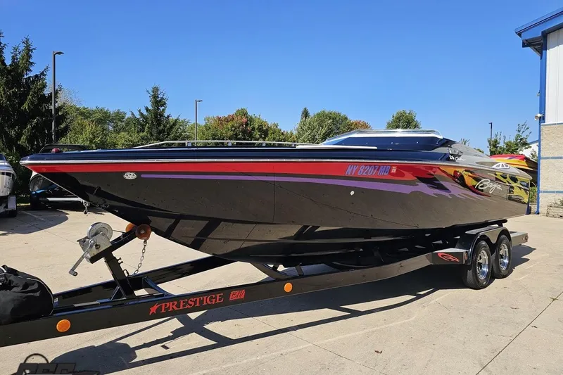 Slide: The Image of 2005 Baja 25 Outlaw speedboat on trailer, sleek design, vibrant colors, outdoor setting. - 18