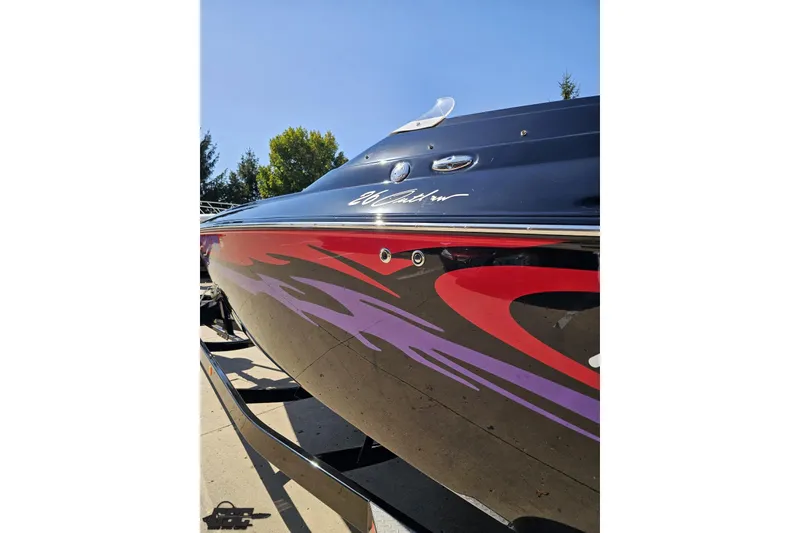 Slide: The Image of 2005 Baja 25 Outlaw boat with vibrant graphics and sleek design. - 27