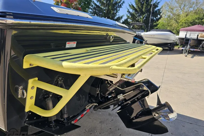 Slide: The Image of 2005 Baja 25 Outlaw boat with yellow swim platform and MerCruiser outdrive. - 32