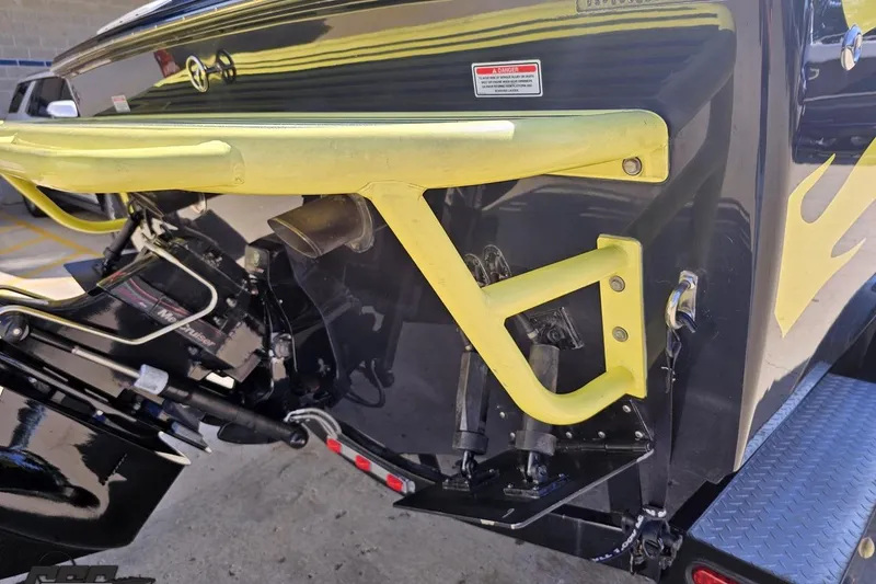 Slide: The Image of 2005 Baja 25 Outlaw boat stern with yellow accents and visible engine components. - 36