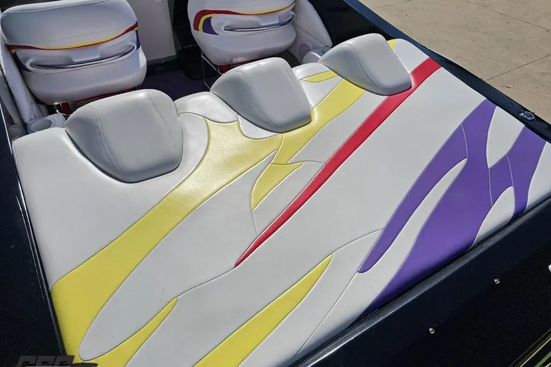Slide: The Image of 2005 Baja 25 Outlaw boat interior with colorful, patterned seating design. - 42