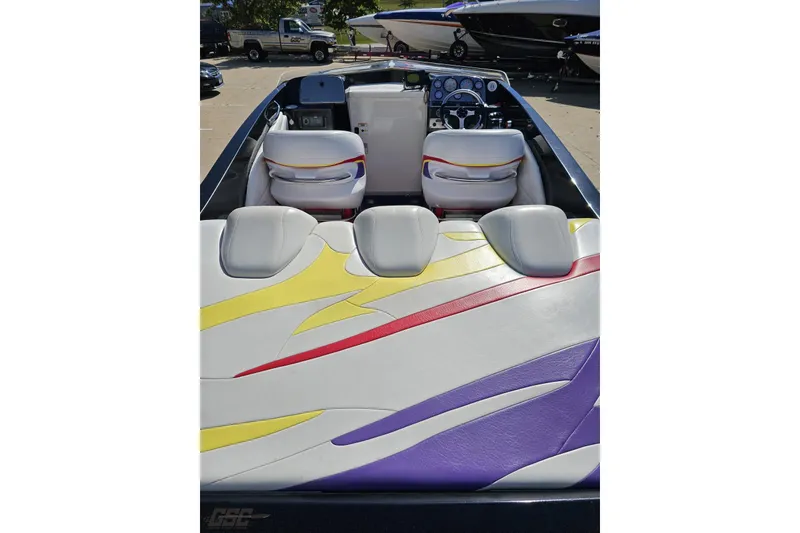 Slide: The Image of 2005 Baja 25 Outlaw boat interior with colorful seating and dashboard. - 43