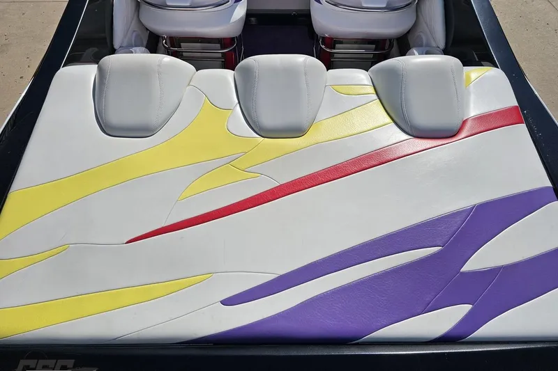 Slide: The Image of 2005 Baja 25 Outlaw boat seat with colorful abstract design in yellow, red, and purple. - 44