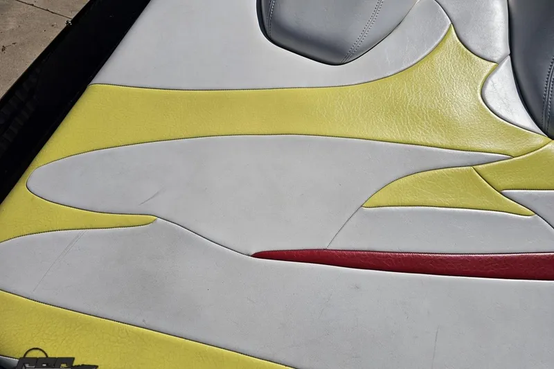 Slide: The Image of 2005 Baja 25 Outlaw boat seat with yellow, white, and red upholstery design. - 46