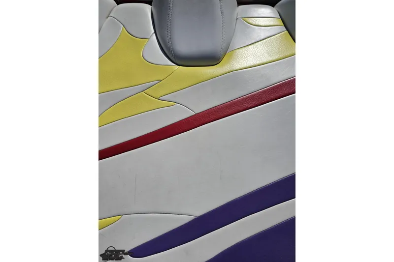 Slide: The Image of Colorful seat design of a 2005 Baja 25 Outlaw boat, featuring yellow, red, and purple accents. - 47