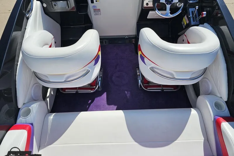 Slide: The Image of Interior of 2005 Baja 25 Outlaw boat with white seats and purple carpet. - 52
