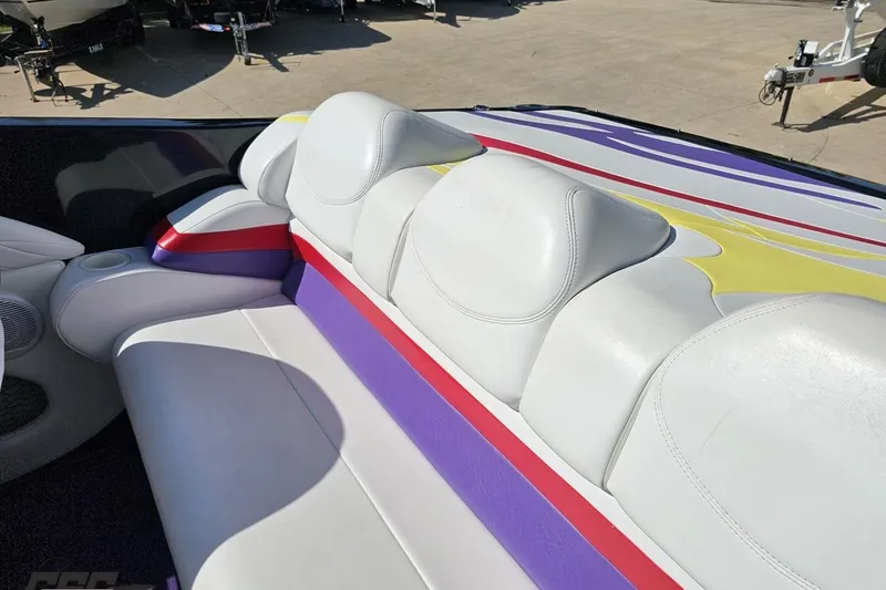 Slide: The Image of 2005 Baja 25 Outlaw boat interior with colorful seating and sleek design. - 54