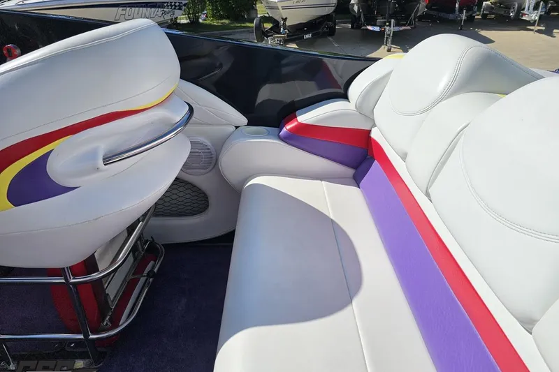 Slide: The Image of 2005 Baja 25 Outlaw boat interior with colorful seating and sleek design. - 55