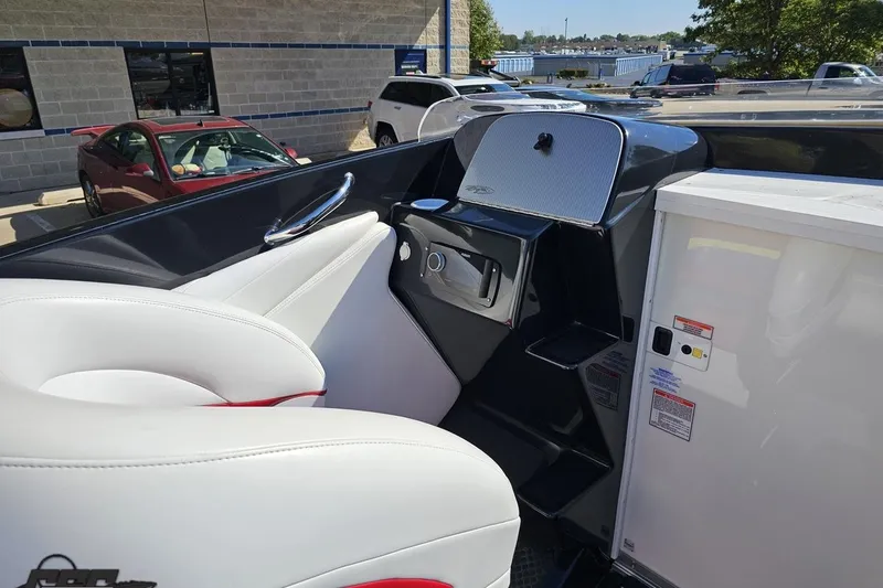 Slide: The Image of 2005 Baja 25 Outlaw boat interior with white seating and control panel. - 61