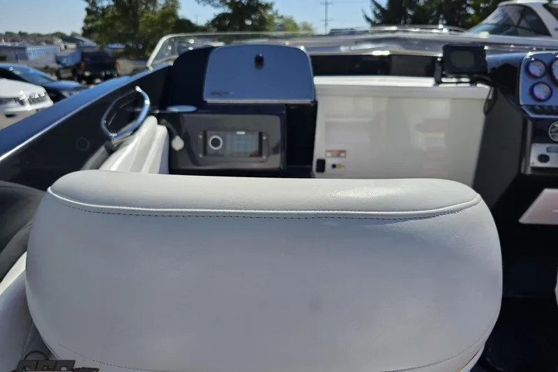 Slide: The Image of 2005 Baja 25 Outlaw boat interior with white seating and dashboard controls. - 62