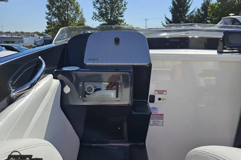 Slide: The Image of 2005 Baja 25 Outlaw boat interior with dashboard and seating, featuring modern controls. - 63