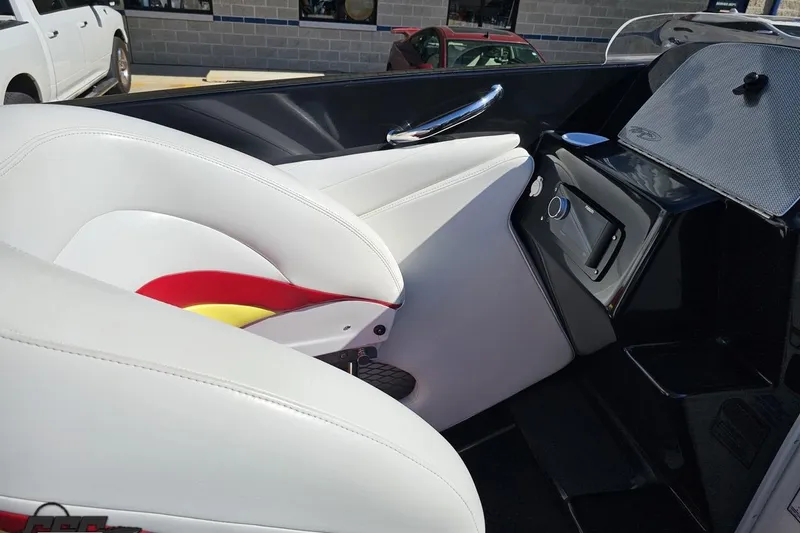 Slide: The Image of 2005 Baja 25 Outlaw boat interior with white and red seating, sleek design. - 64