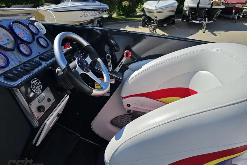 Slide: The Image of 2005 Baja 25 Outlaw boat cockpit with steering wheel and gauges. - 66