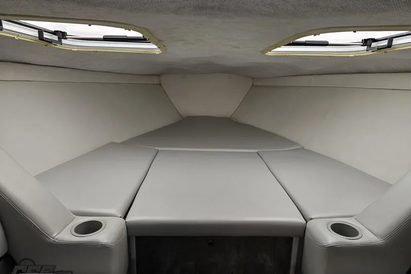 Slide: The Image of 2005 Baja 25 Outlaw cabin interior with gray upholstery and cup holders. - 78