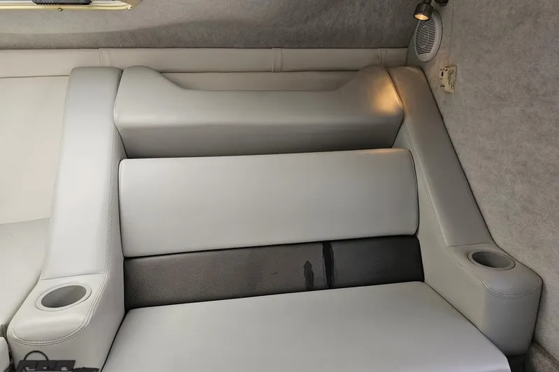 Slide: The Image of 2005 Baja 25 Outlaw boat interior with gray seating and cup holders. - 82