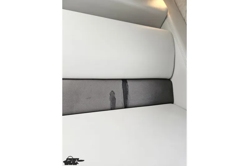 Slide: The Image of 2005 Baja 25 Outlaw boat interior with white and black seating. - 83