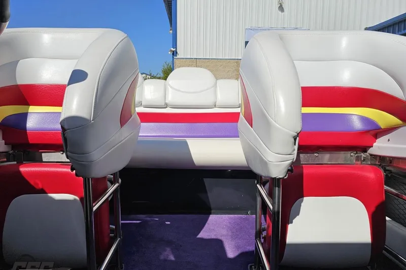 Slide: The Image of 2005 Baja 25 Outlaw boat interior with colorful seating and vibrant upholstery. - 85