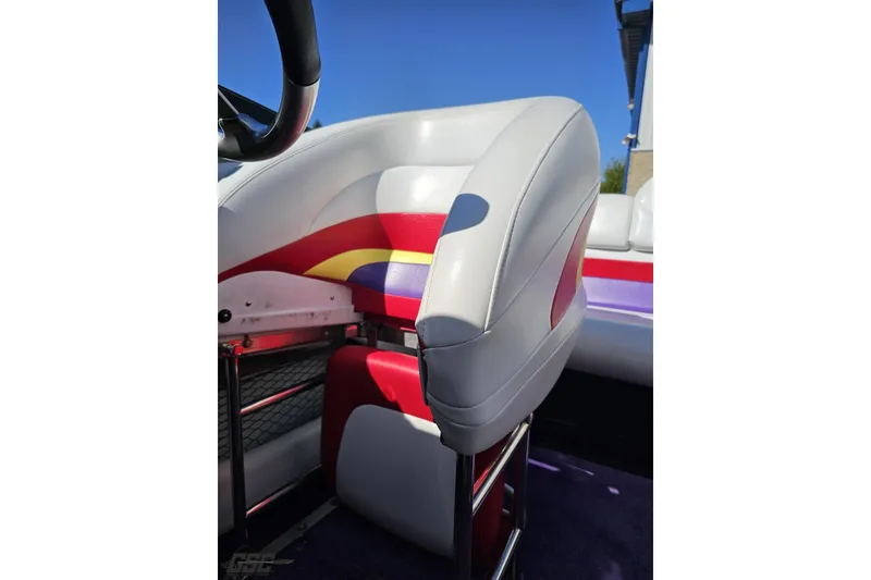 Slide: The Image of 2005 Baja 25 Outlaw boat seat with colorful upholstery and steering wheel. - 86