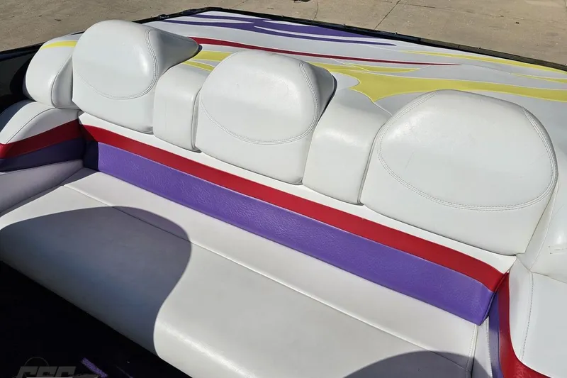 Slide: The Image of 2005 Baja 25 Outlaw boat interior with colorful white, red, and purple seating. - 89