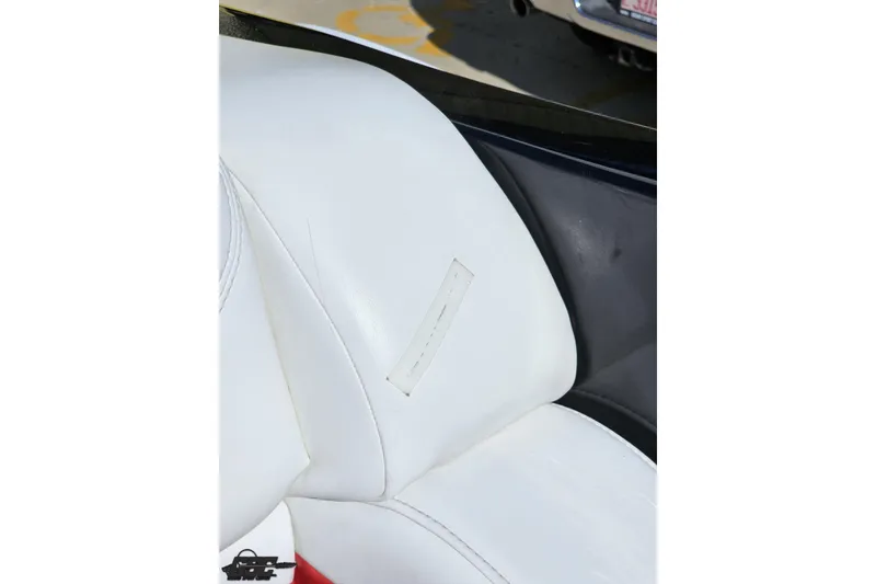 Slide: The Image of White leather seat detail in a 2005 Baja 25 Outlaw boat. - 90