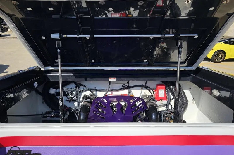 Slide: The Image of 2005 Baja 25 Outlaw engine compartment with open hatch, showcasing internal components. - 94