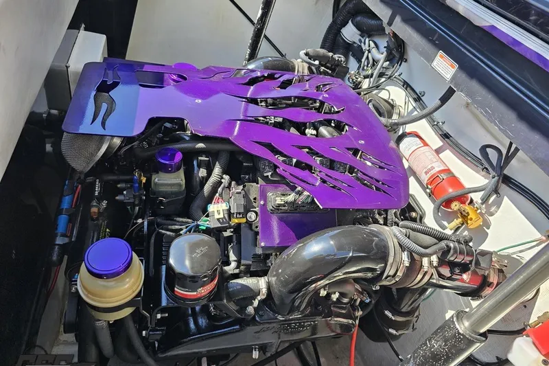 Slide: The Image of 2005 Baja 25 Outlaw engine with custom purple cover and visible components. - 97