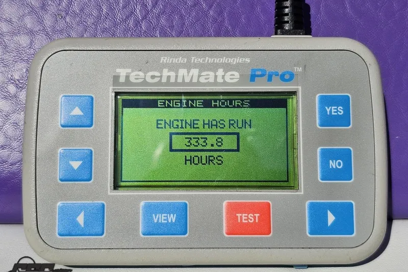Slide: The Image of TechMate Pro device displaying 333.8 engine hours for 2005 Baja 25 Outlaw. - 98